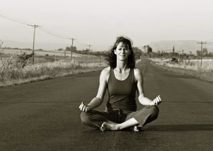 Chrisna Ashforth teaching Kundalini yoga in a serene outdoor setting, demonstrating proper form and spiritual connection